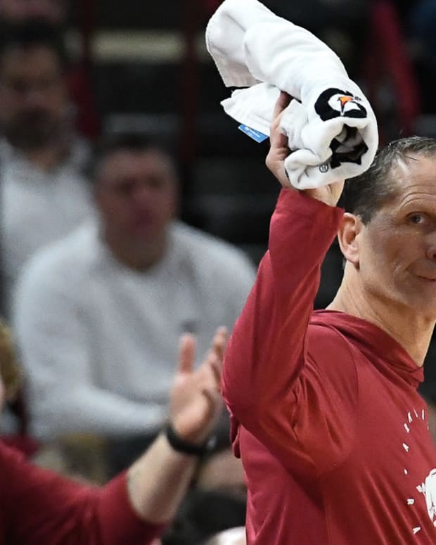 Razorbacks coach Eric Musselman waves towel after a call against UNC Wilmington